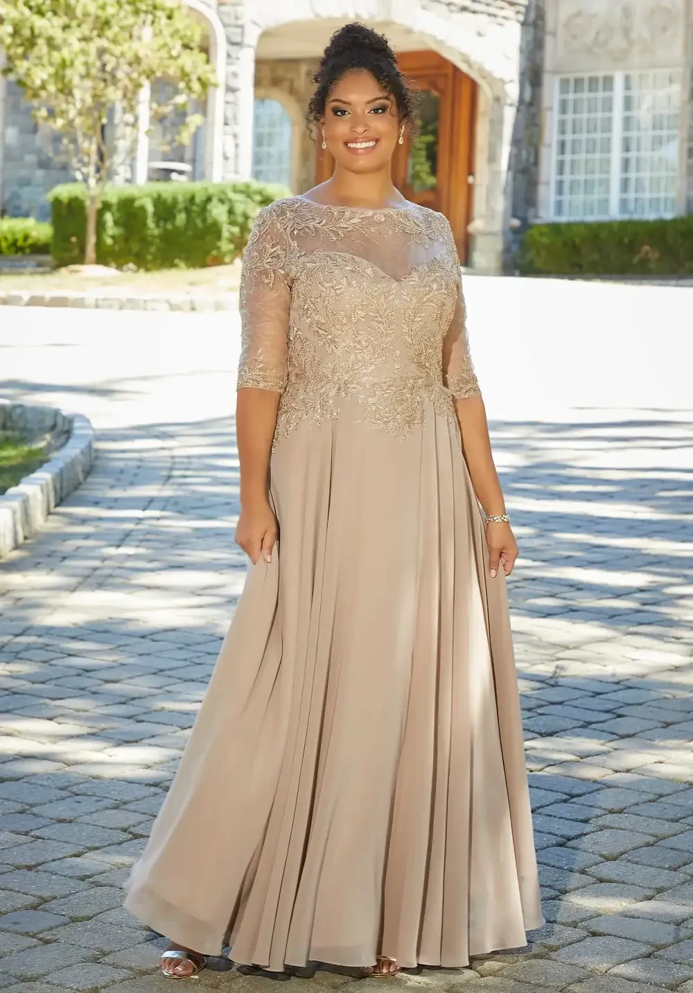 model is wearing a gold quarter sleeve mothers gown