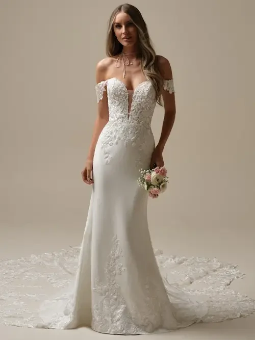 Model is wearing an off the shoulder wedding dress with a plunging neckline
