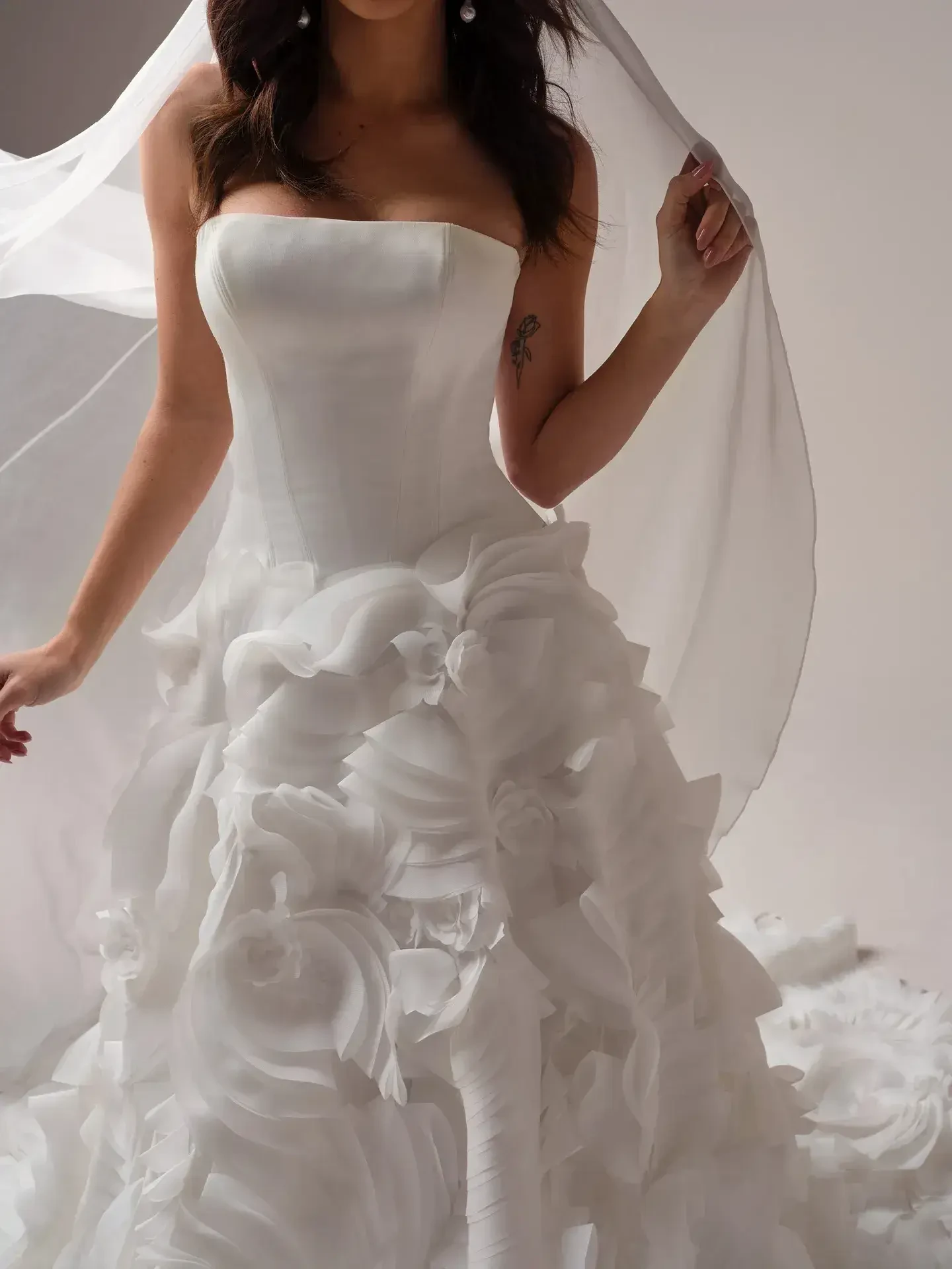 model is wearing a strapless a-line wedding dress