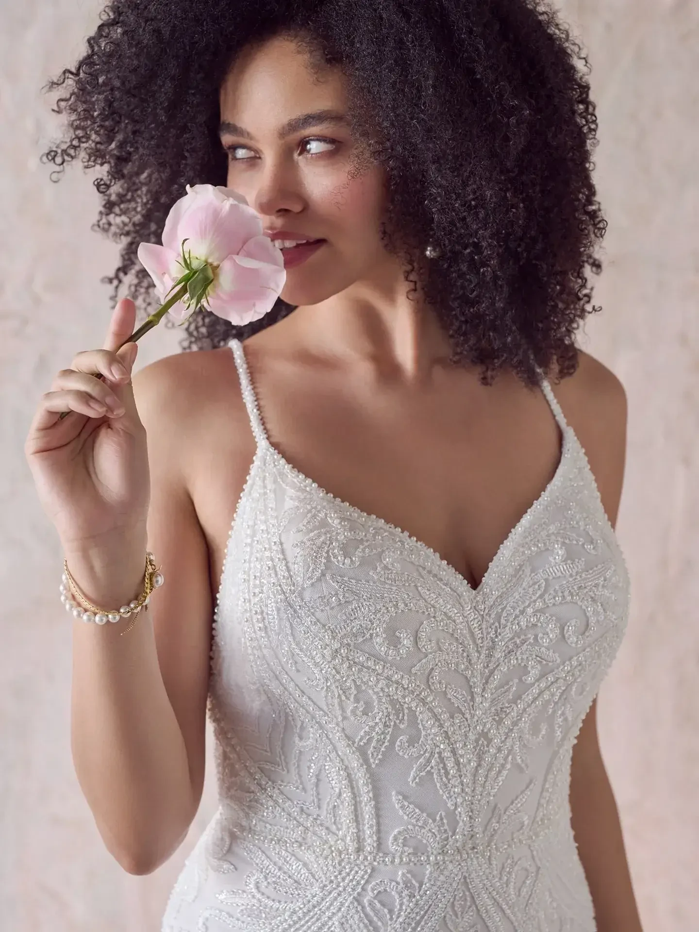 model is wearing an open back sleeveless wedding dress