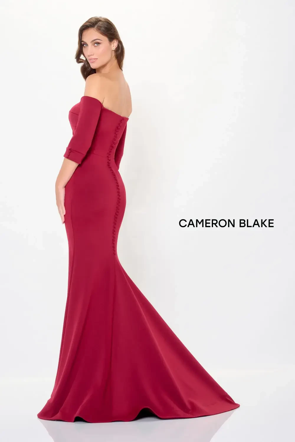 model is wearing an off the shoulder red mothers gown