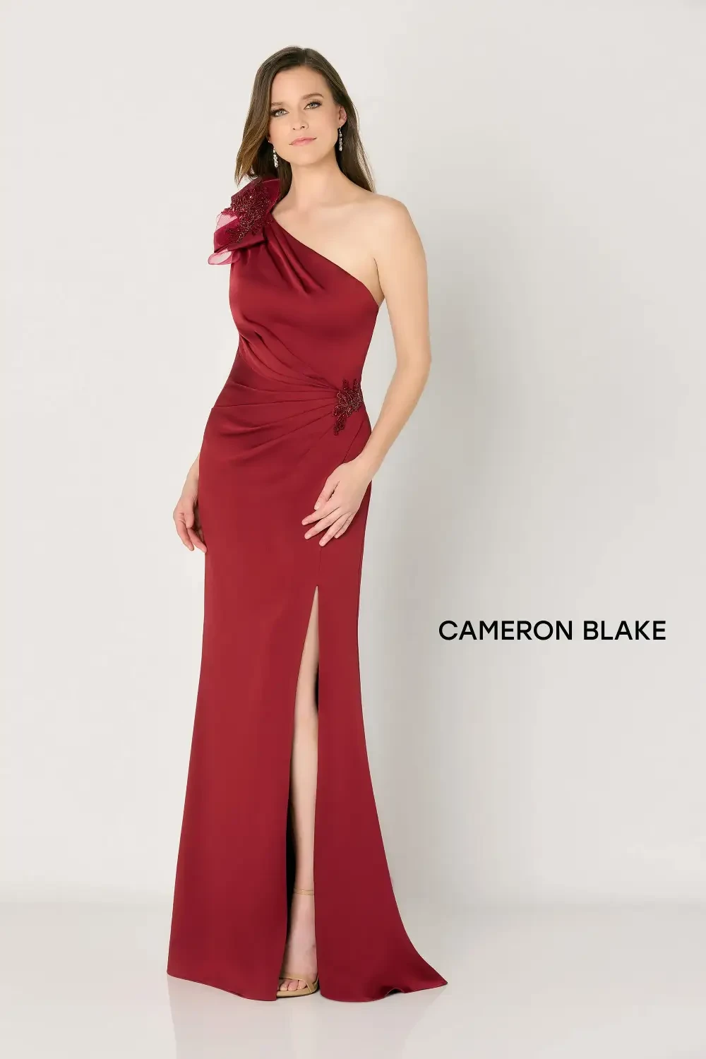 model is wearing a one shoulder red mothers gown