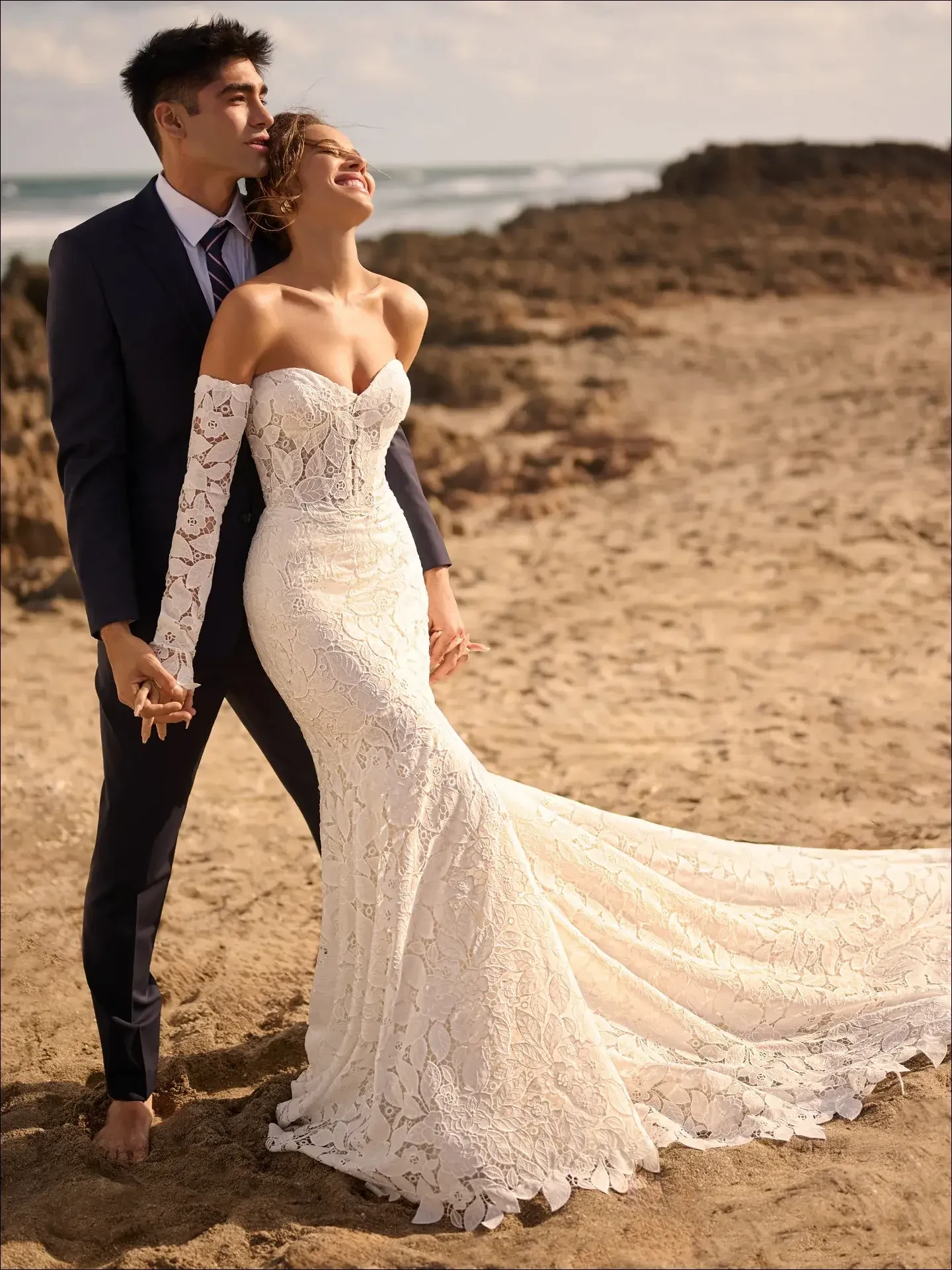 model is wearing an off the shoulder lace wedding gown
