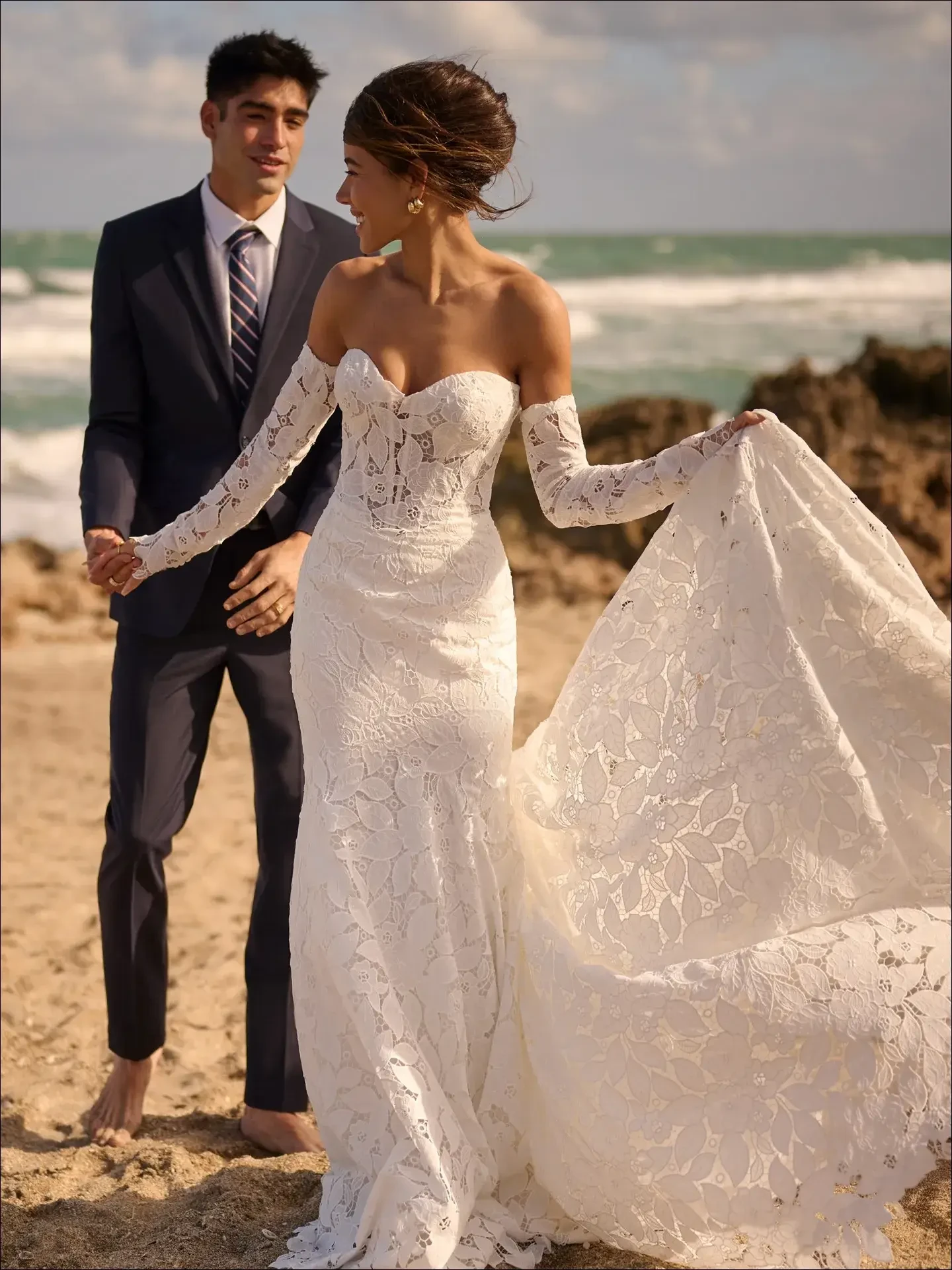 model is wearing an off the shoulder lace wedding gown