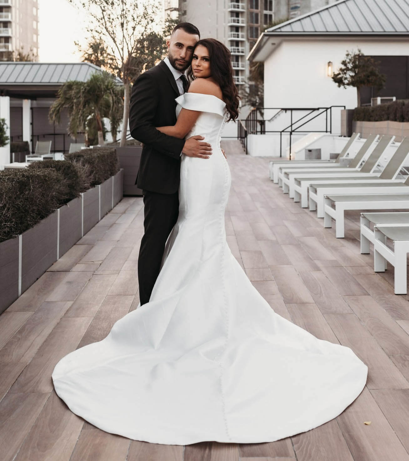 Сouple wearing a white gown and a black suit