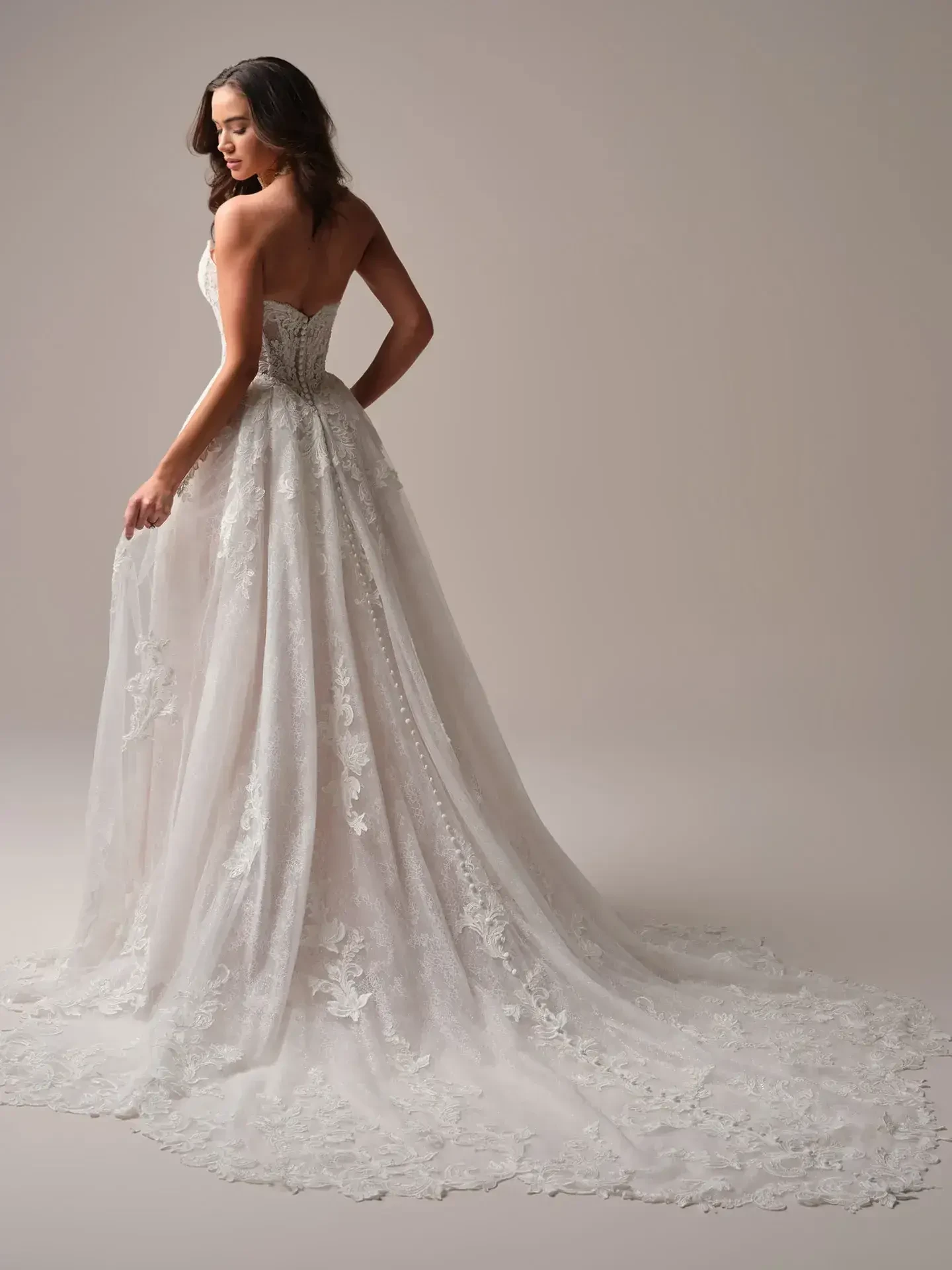 model is wearing an off the shoulder a-line wedding dress
