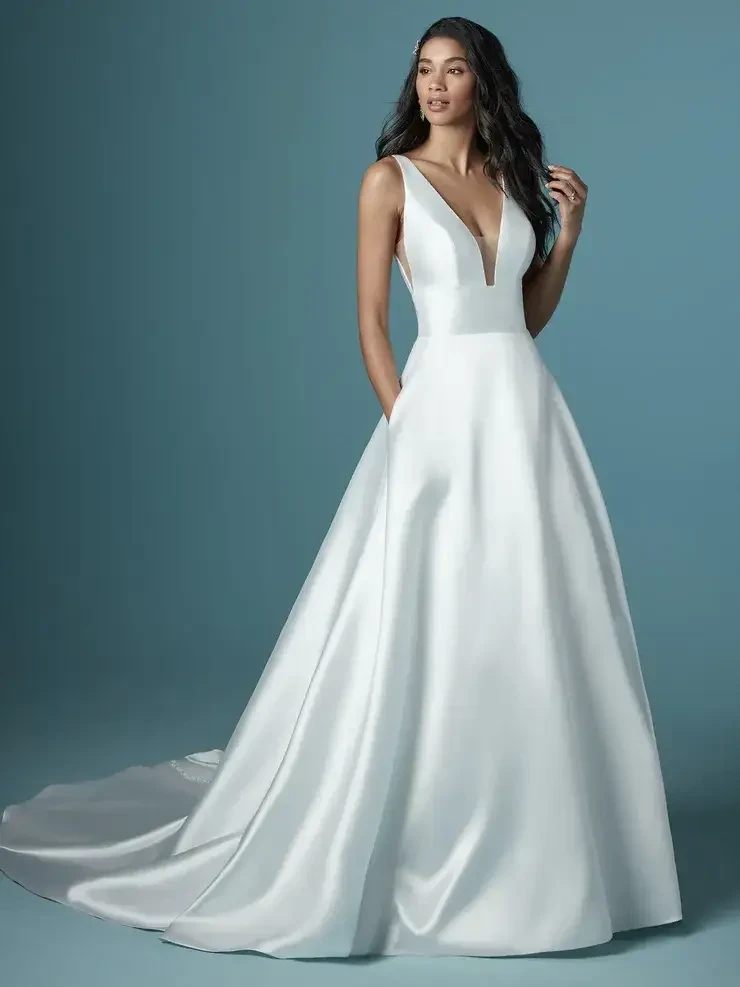 model is wearing a sleeveless a-line wedding gown